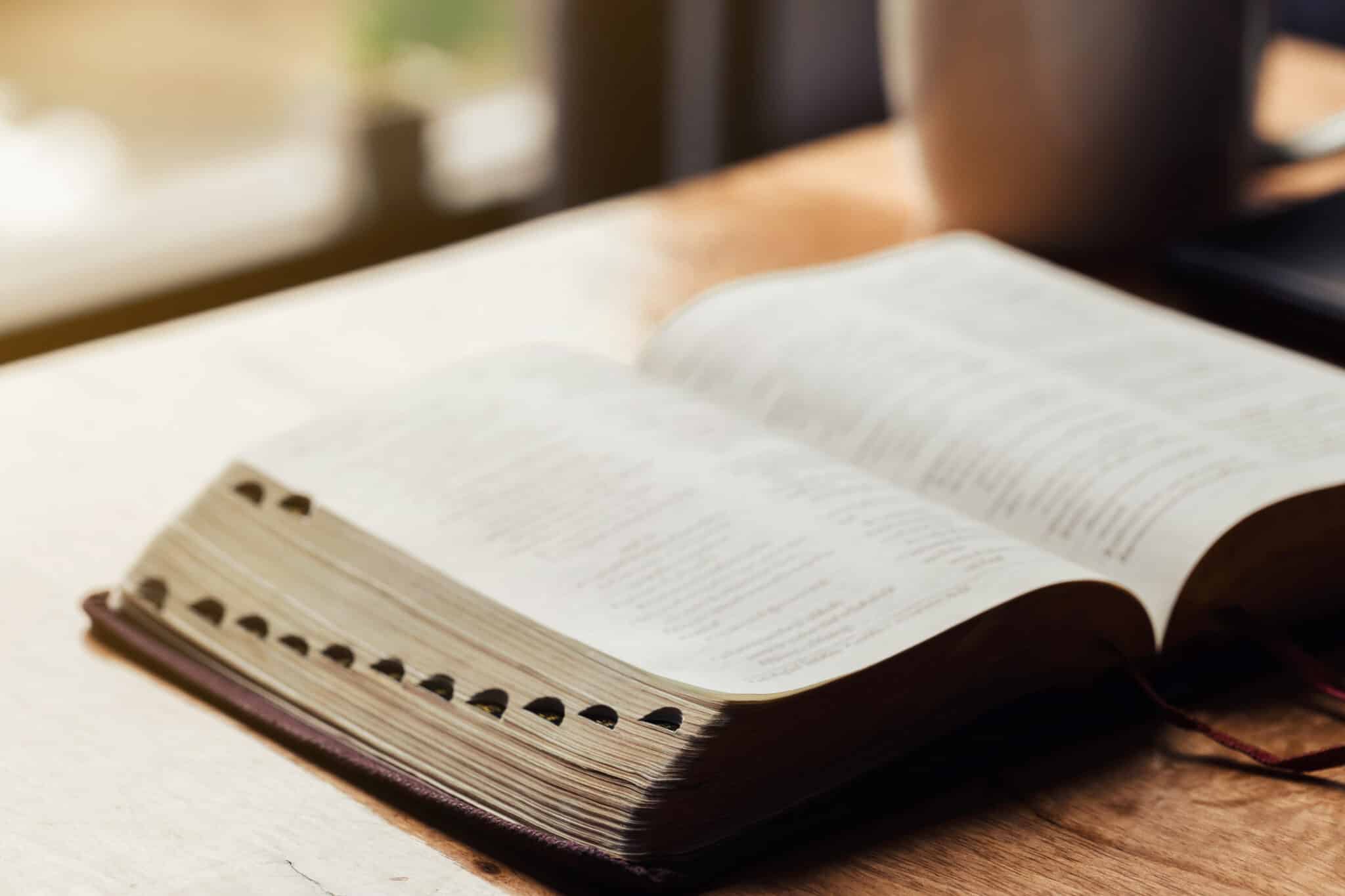 open bible on wooden table featured image