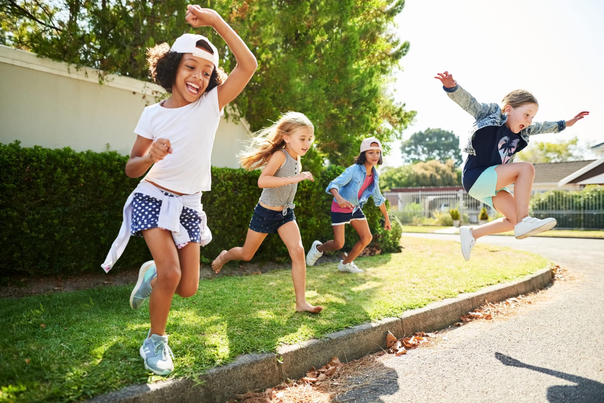 Happy kids jumping and playing outside