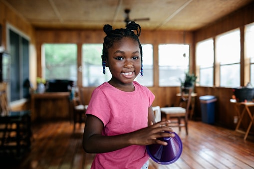 young african american girl playing game inside