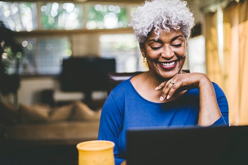 cheerful african american woman working on computer