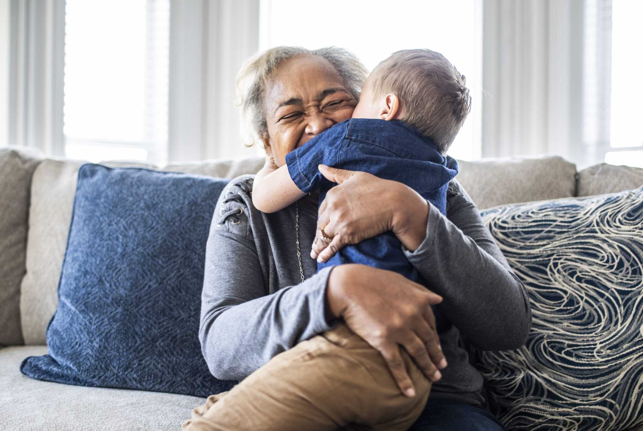 grandmother embracing grandson