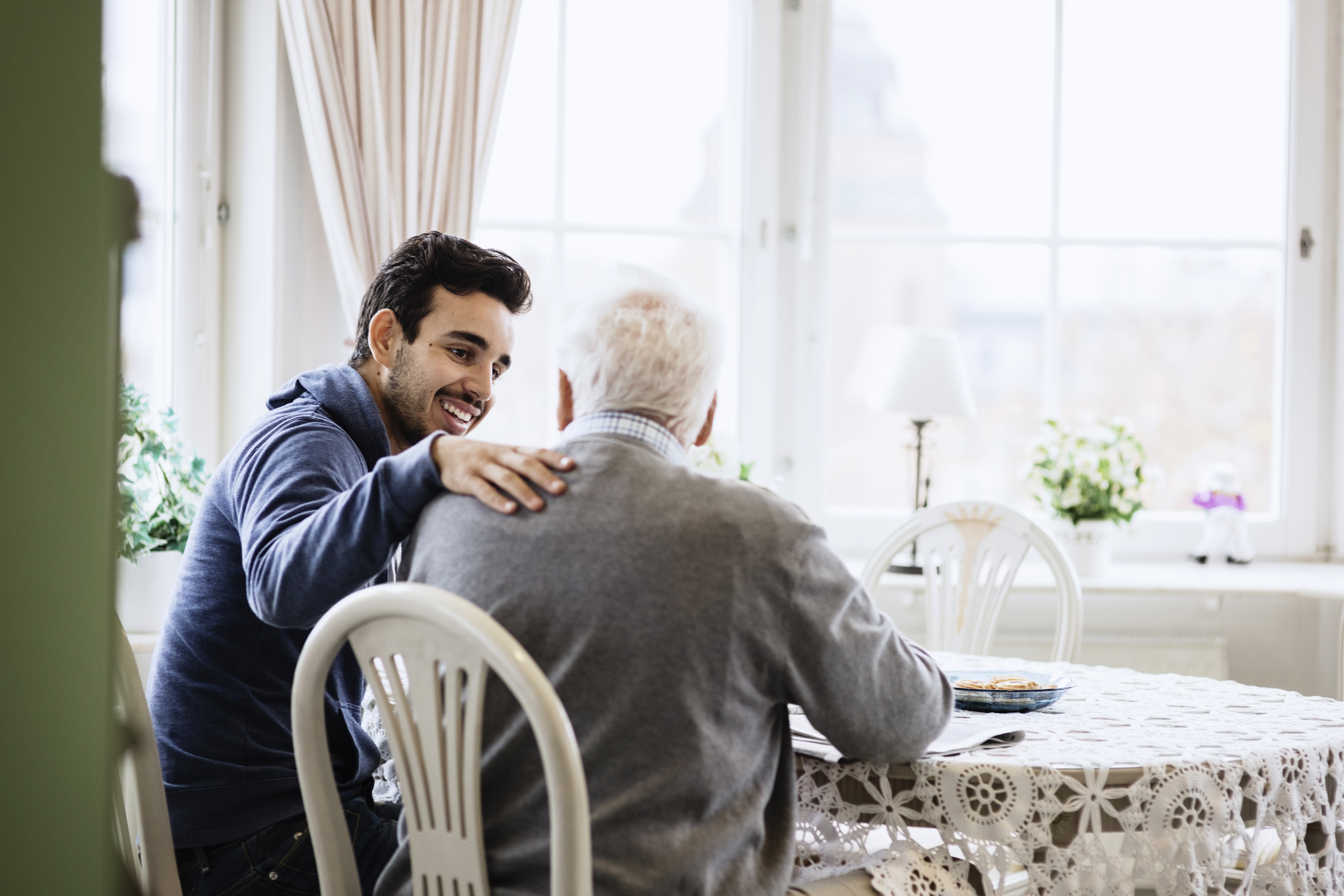grandfather and grandson sitting at a table