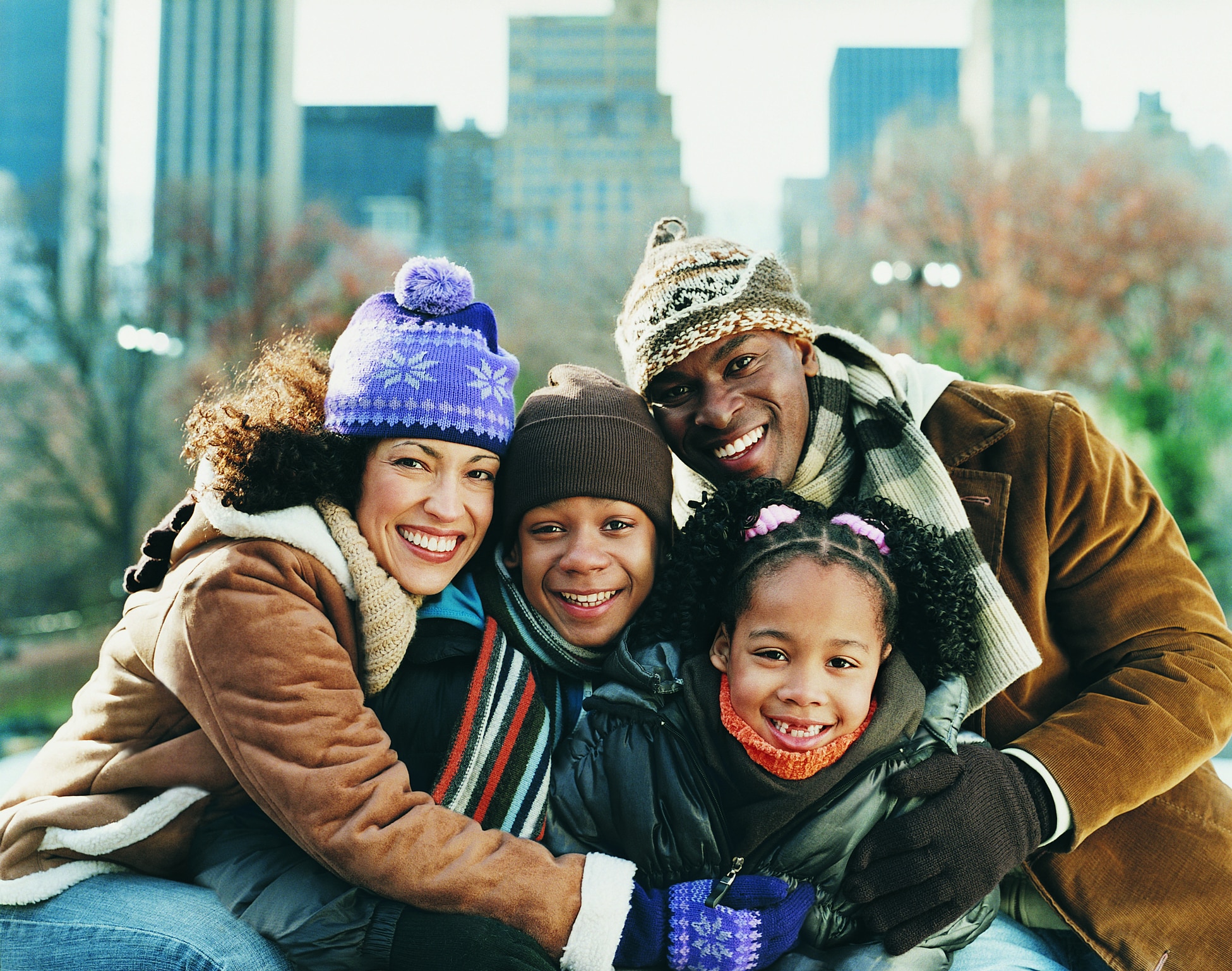 portrait of a bundled up family in a park