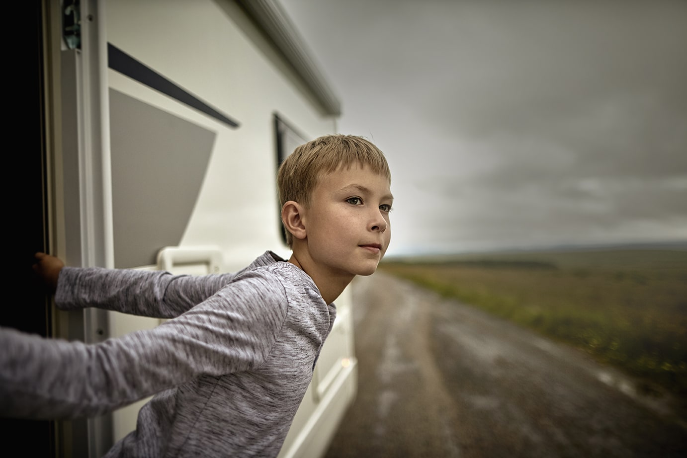 Boy leaning out of RV