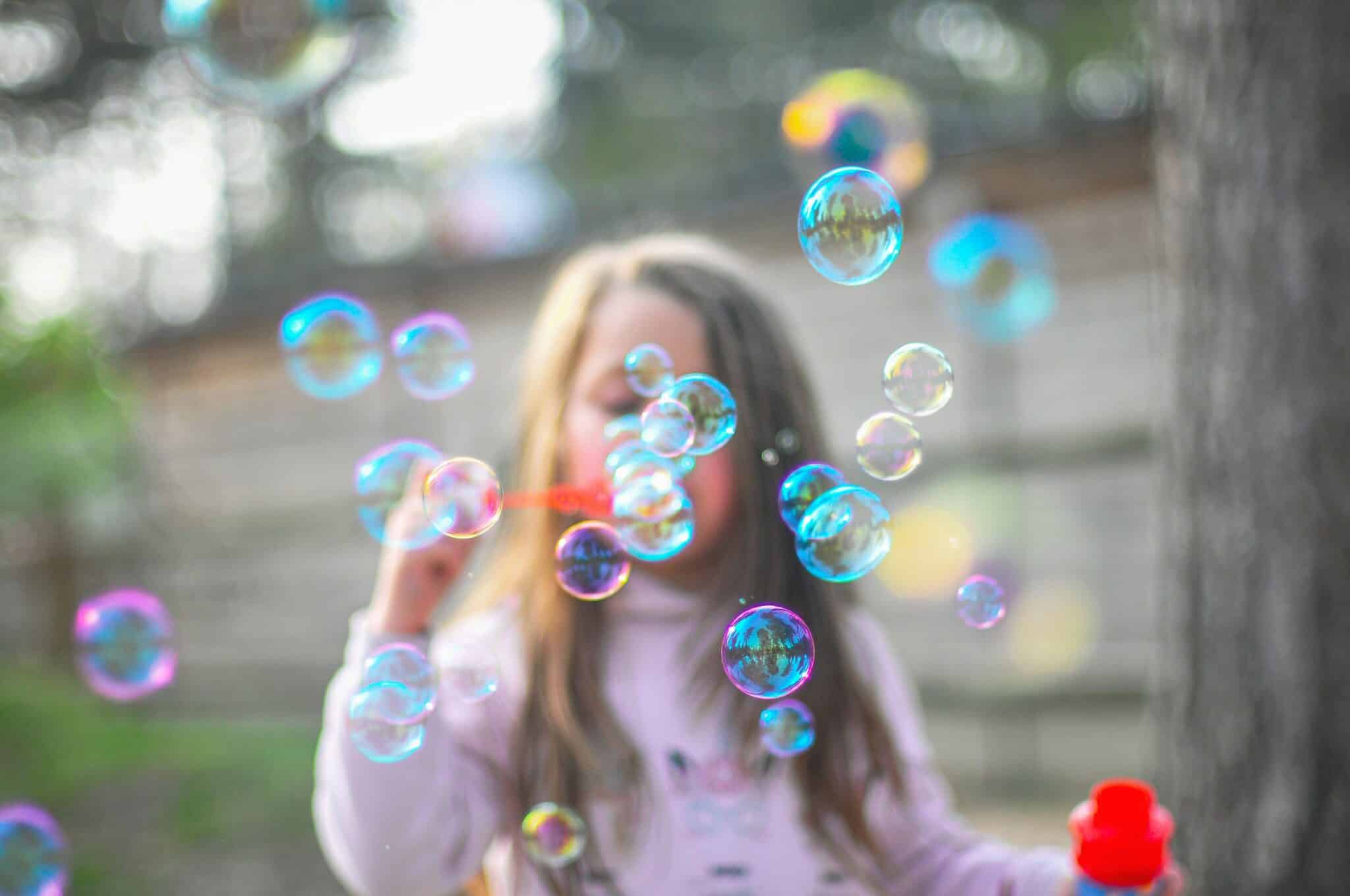 girl blowing bubbles