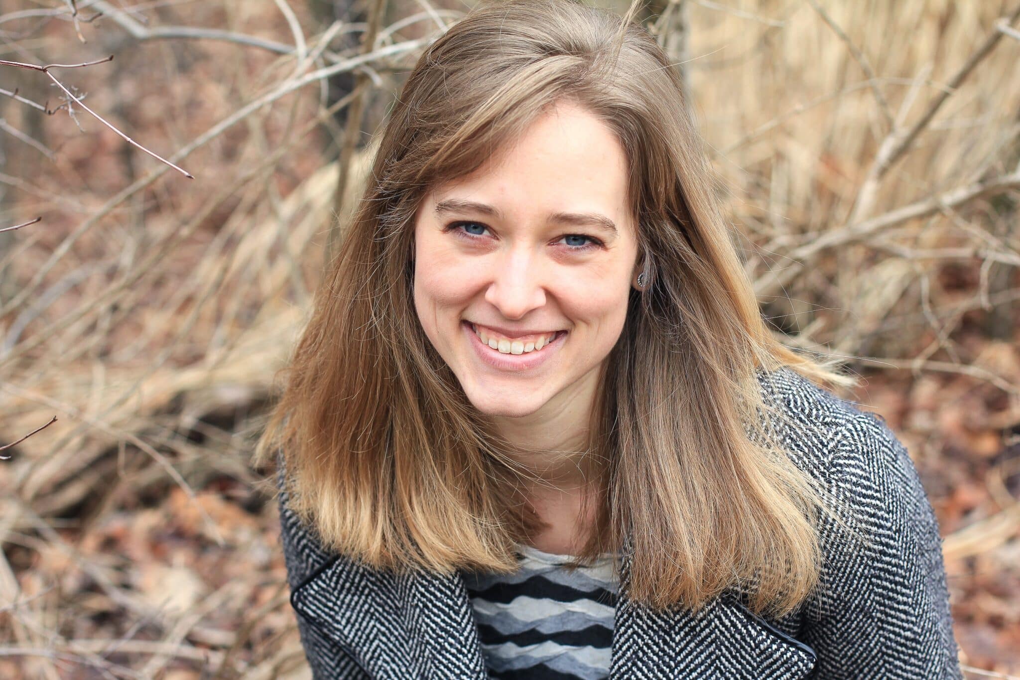woman smiling outside in the fall
